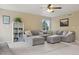 Bright living room with a comfortable gray sectional sofa and stylish decorations at 10570 Humboldt Peak Way, Parker, CO 80138