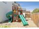 Wooden play structure with slides and swings, perfect for backyard Gathering fun at 10570 Humboldt Peak Way, Parker, CO 80138