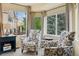 Cozy sitting area with patterned armchairs and natural light from large windows at 10570 Humboldt Peak Way, Parker, CO 80138