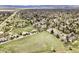Scenic aerial view of a quiet neighborhood near a serene lake and vast greenbelt area at 7060 S Windsor St, Littleton, CO 80128