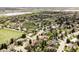 Lovely aerial view showcases lush neighborhood with proximity to community pool and green spaces at 7060 S Windsor St, Littleton, CO 80128
