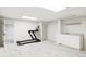 Finished basement featuring a gym area with a treadmill and a wet bar for entertainment at 7060 S Windsor St, Littleton, CO 80128