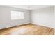 Empty bedroom with natural light and hardwood flooring at 7060 S Windsor St, Littleton, CO 80128