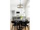 Bright dining area featuring a modern light fixture and a view into a stylish kitchen at 7060 S Windsor St, Littleton, CO 80128