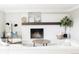Cozy living room fireplace with white brick and a decorative mantel at 7060 S Windsor St, Littleton, CO 80128