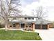Charming two-story brick home with manicured lawn and attached two-car garage at 7060 S Windsor St, Littleton, CO 80128