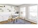 Bright home office with built-in shelves, a glass desk, and natural light at 7060 S Windsor St, Littleton, CO 80128