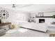 Sun-filled living room with a large white sofa, fireplace, and neutral decor at 7060 S Windsor St, Littleton, CO 80128