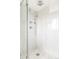Modern shower with sleek fixtures and marble tile at 7060 S Windsor St, Littleton, CO 80128