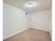 Unfinished basement with tan carpet, white walls, and a window allowing natural light at 9057 E Oxford Dr, Denver, CO 80237