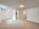 Spacious basement area featuring a carpeted floor and ample lighting, perfect for various uses at 9057 E Oxford Dr, Denver, CO 80237