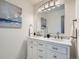 Elegant bathroom featuring a double sink vanity with marble countertop and modern lighting fixture at 9057 E Oxford Dr, Denver, CO 80237