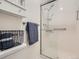 Bathroom showcasing a glass-enclosed shower, towel rack, and built-in storage at 9057 E Oxford Dr, Denver, CO 80237