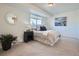 Cozy bedroom with natural light, neutral color scheme, complemented by a decorative mirror and artwork at 9057 E Oxford Dr, Denver, CO 80237