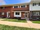 Brick townhouse with bright windows and a welcoming entryway at 9057 E Oxford Dr, Denver, CO 80237