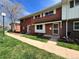 Charming brick townhouse with well-maintained lawn and sidewalk, ideal for comfortable living at 9057 E Oxford Dr, Denver, CO 80237