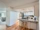Modern kitchen featuring white cabinets, stainless steel appliances, and a breakfast bar with stool seating at 9057 E Oxford Dr, Denver, CO 80237