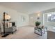 Bright living room with fireplace, large window, and neutral tones perfect for relaxing and entertaining guests at 9057 E Oxford Dr, Denver, CO 80237
