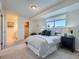 Serene main bedroom with large window, neutral decor, and access to attached bath at 9057 E Oxford Dr, Denver, CO 80237