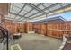 Relaxing patio with a covered pergola, privacy fence, and ample space for outdoor enjoyment at 9057 E Oxford Dr, Denver, CO 80237