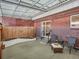 Cozy covered patio area with furniture and brick accents, perfect for relaxation at 9057 E Oxford Dr, Denver, CO 80237