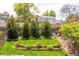 Lush backyard showcasing a well-maintained lawn, garden, mature trees, and charming landscaping at 10911 Tennyson Ct, Westminster, CO 80031