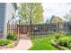 Backyard gate leading to lush, green lawn, offering a private and inviting outdoor space at 10911 Tennyson Ct, Westminster, CO 80031