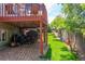 Spacious yard with lawn mower and garden equipment storage under the deck, and a lush lawn at 10911 Tennyson Ct, Westminster, CO 80031