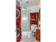 Functional bathroom featuring a stand-up shower, red front-loading washer and dryer, providing convenience at 10911 Tennyson Ct, Westminster, CO 80031