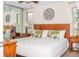 Bright bedroom features a wooden bed frame, white linens, and bedside tables with lamps at 10911 Tennyson Ct, Westminster, CO 80031
