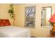 Bedroom features yellow walls, a window with blinds, and simple furnishings at 10911 Tennyson Ct, Westminster, CO 80031