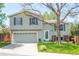 Charming two-story home with an attached garage, manicured lawn, and mature trees, creating a welcoming facade at 10911 Tennyson Ct, Westminster, CO 80031