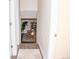 Hallway leading to a dining area with wood flooring and a view of a well-lit dining room at 10911 Tennyson Ct, Westminster, CO 80031