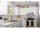 Bright kitchen featuring white cabinets, stainless steel appliances, and a window offering natural light at 10911 Tennyson Ct, Westminster, CO 80031