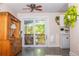 Bright living space with a sliding glass door to a deck, complemented by a wooden hutch and indoor plants at 10911 Tennyson Ct, Westminster, CO 80031