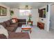 Spacious living room featuring a comfortable brown sectional sofa and a large flat-screen TV for relaxed entertaining at 10911 Tennyson Ct, Westminster, CO 80031