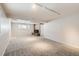 Spacious basement featuring neutral carpet, brick fireplace, natural light and track lighting at 2221 S Arbutus Ct, Lakewood, CO 80228
