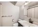 Full bathroom features neutral colors, toilet, sink and shower at 2221 S Arbutus Ct, Lakewood, CO 80228