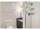 Bathroom featuring a granite-topped vanity, and a glass enclosed shower with silver fixtures at 2221 S Arbutus Ct, Lakewood, CO 80228