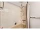 Bathroom featuring a tiled shower and tub combination with neutral-toned walls and fixtures at 2221 S Arbutus Ct, Lakewood, CO 80228