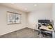 Bedroom features light neutral color palette, carpeted floors, and a large window for natural light at 2221 S Arbutus Ct, Lakewood, CO 80228