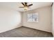 Neutral bedroom features ceiling fan, carpeted floors, and a window for natural light at 2221 S Arbutus Ct, Lakewood, CO 80228