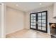 Bright dining space featuring French doors and tile flooring at 2221 S Arbutus Ct, Lakewood, CO 80228