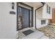 Close-up of the elegant front door with stylish hardware and a welcoming entrance at 2221 S Arbutus Ct, Lakewood, CO 80228