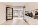 Bright kitchen featuring granite countertops, tile floors, and stylish glass doors leading to another room at 2221 S Arbutus Ct, Lakewood, CO 80228