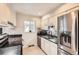 Modern kitchen featuring stainless steel appliances, granite countertops, and stylish backsplash at 2221 S Arbutus Ct, Lakewood, CO 80228