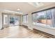 Bright living room with hardwood floors, skylights, large windows, and view of the backyard at 2221 S Arbutus Ct, Lakewood, CO 80228