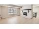Spacious living room with fireplace, large window, and tile floors at 2221 S Arbutus Ct, Lakewood, CO 80228