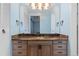 Bathroom vanity with rich wood cabinets, granite countertops and ample storage space at 7877 E Mississippi Ave # 607, Denver, CO 80247