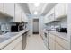 Bright kitchen with white cabinetry, stainless steel appliances, ample counter space, and tile flooring at 7877 E Mississippi Ave # 607, Denver, CO 80247